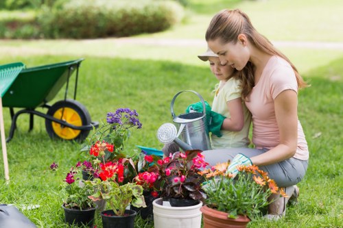 Staff wearing PPE while operating garden machinery